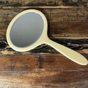Handheld mirror vintage French ivory celluloid. Beveled glass.